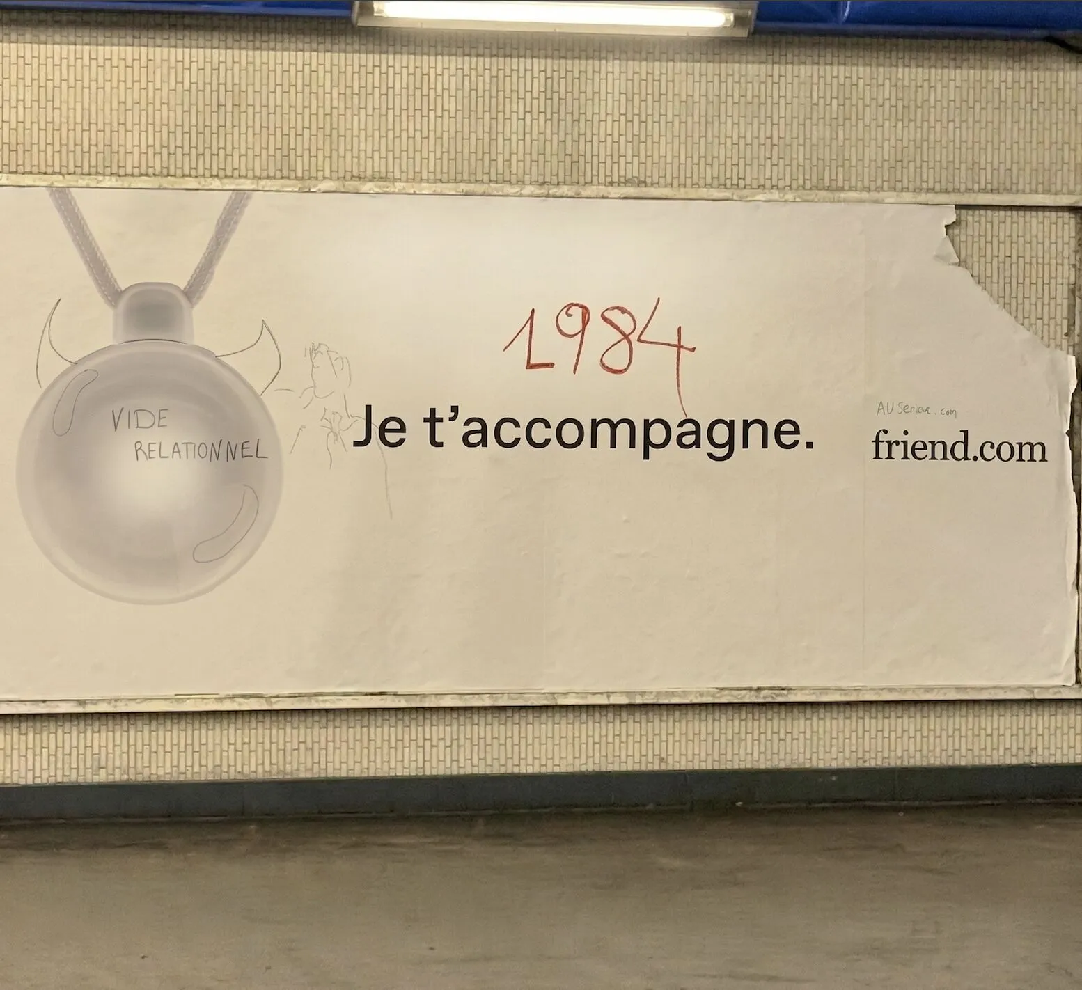 Vandalised AI device ad in Paris subway station photo